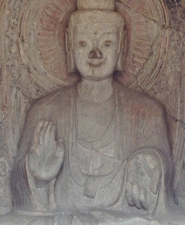 Ancient Chinese Buddha statue in Luyong giving blessings